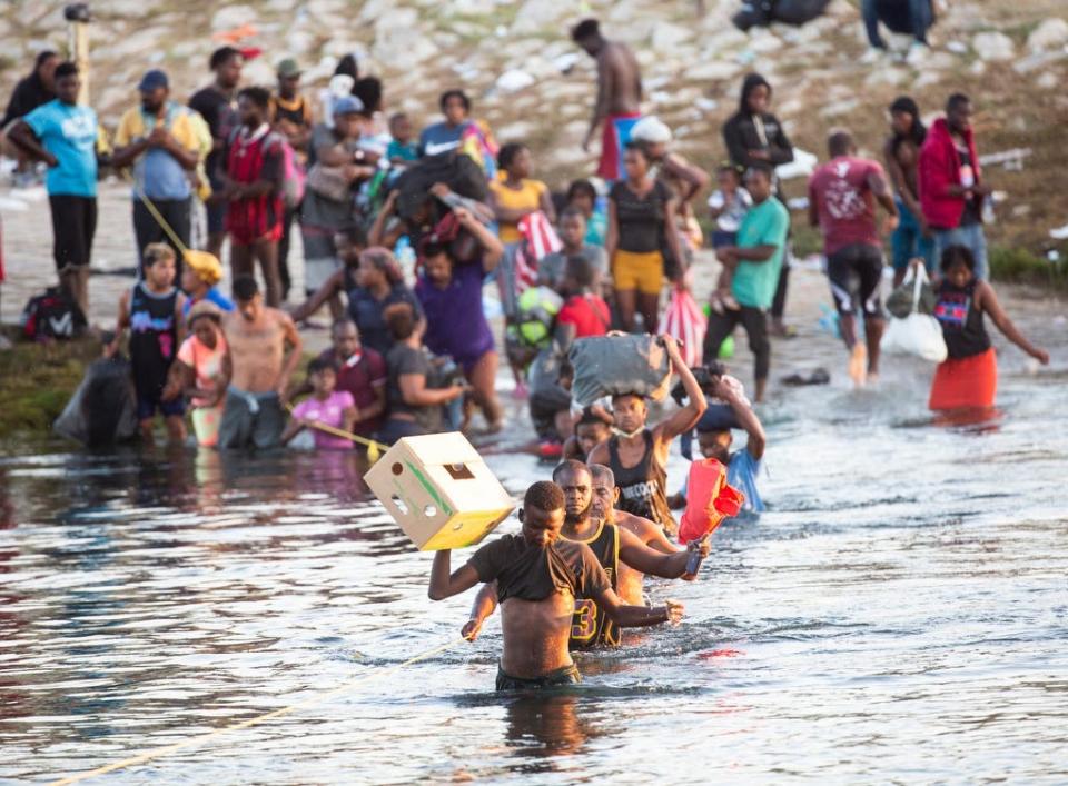 Haitian migrants cross the Rio Grande south into Ciudad Acuna from Del Rio, Texas, as they leave the migrant encampment underneath the Del Rio International Bridge after concerns of food scarcity and expulsions to Haiti on Monday Sept. 20, 2021.