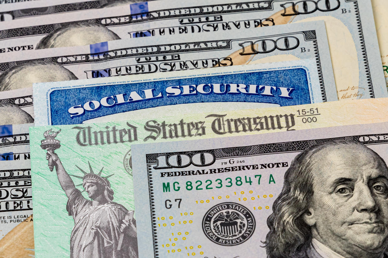 Social Security check and U.S. dollars. (Getty Images)