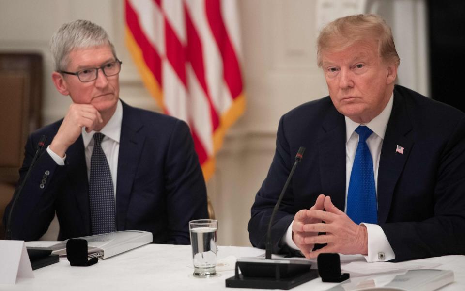 Tim Cook and Donald Trump are at loggerheads for the second time in four years over unlocking iPhones - AFP