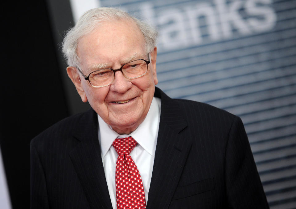 A man in a suit and tie and glasses, Warren Buffet, smiles. (Source: AP)
