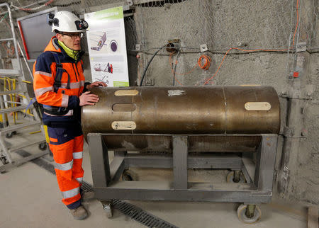 Mathieu Saint-Louis, spokesperson for the French National Radioactive Waste Management Agency ANDRA, stands besides an empty nuclear waste container at the underground research laboratory of the Agency, located 500 meters underground, in Bure, France, April 5, 2018. Picture taken April 5, 2018. REUTERS/Vincent Kessler