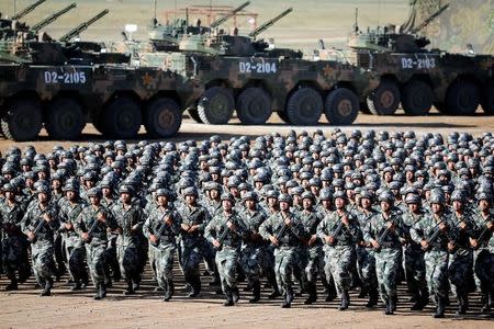 Soldiers of China's People's Liberation Army (PLA) get ready for the military parade to commemorate the 90th anniversary of the foundation of the army at Zhurihe military training base in Inner Mongolia Autonomous Region, China, July 30, 2017. China Daily via REUTERS