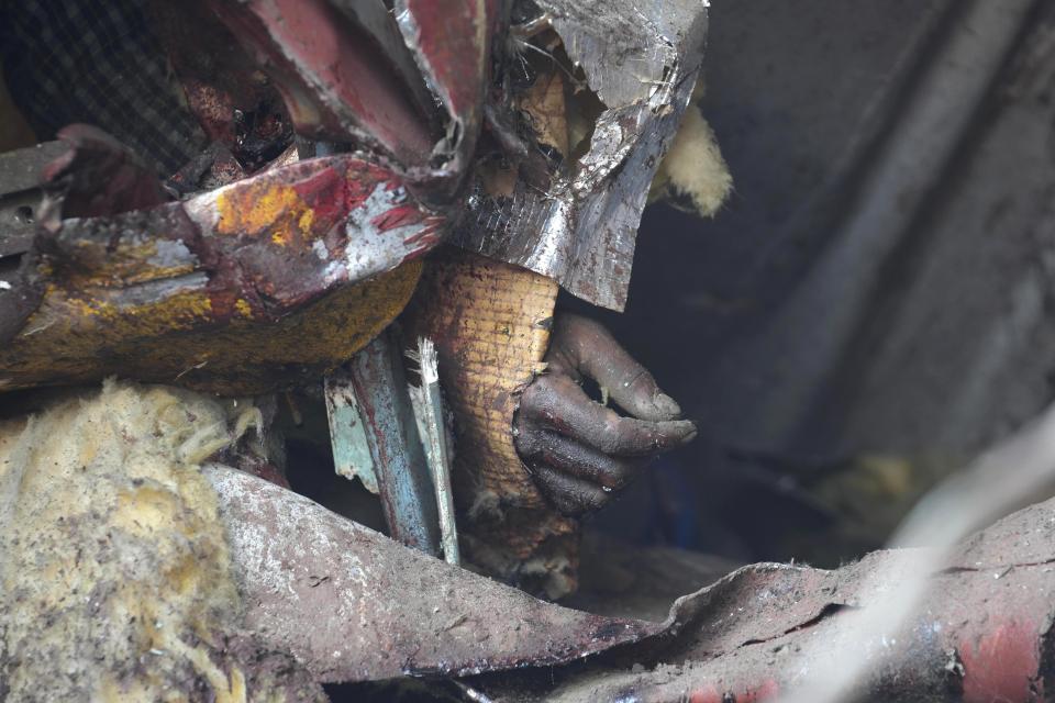 EDS NOTE GRAPHIC CONTENT- The hand of a victim is seen at the site of passenger trains that derailed in Balasore district, in the eastern Indian state of Orissa, Saturday, June 3, 2023. Rescuers are wading through piles of debris and wreckage to pull out bodies and free people after two passenger trains derailed in India, killing more than 280 people and injuring hundreds as rail cars were flipped over and mangled in one of the country’s deadliest train crashes in decades. (AP Photo/Rafiq Maqbool)