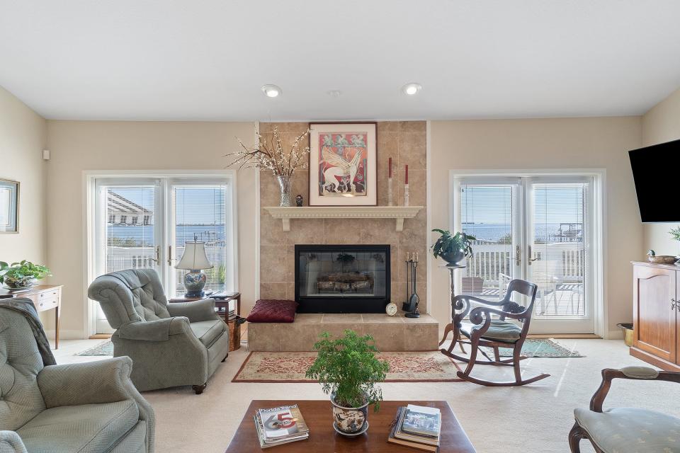 Enjoy conversation by the fireplace with a water view.