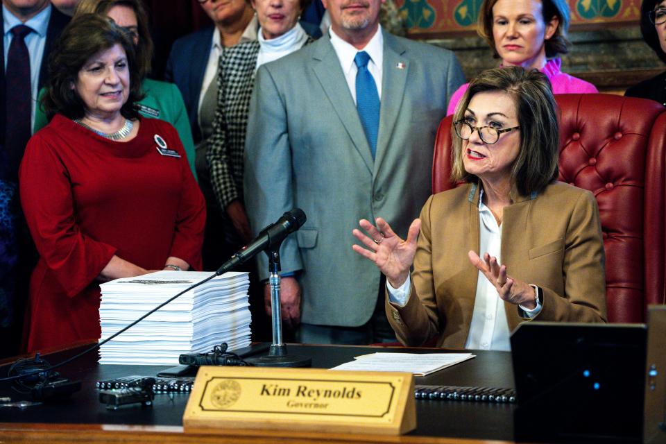 Gov. Kim Reynolds speaks during a bill signing ceremony to reorganize state government on Tuesday, April 4, 2023, at the Iowa State Capitol in Des Moines, Iowa.