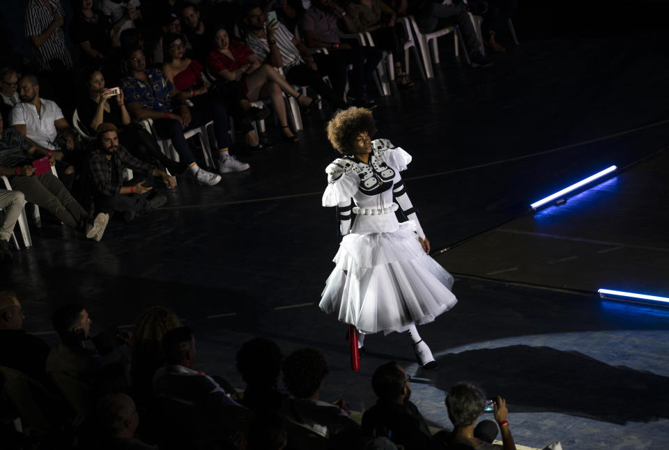 A model wears a creation from "Clandestina," the first Cuban independent urban fashion brand, during a launch for the 2020 collection called Sports Glories in Havana, Cuba, Friday, Nov. 22, 2019. (AP Photo/Ramon Espinosa)