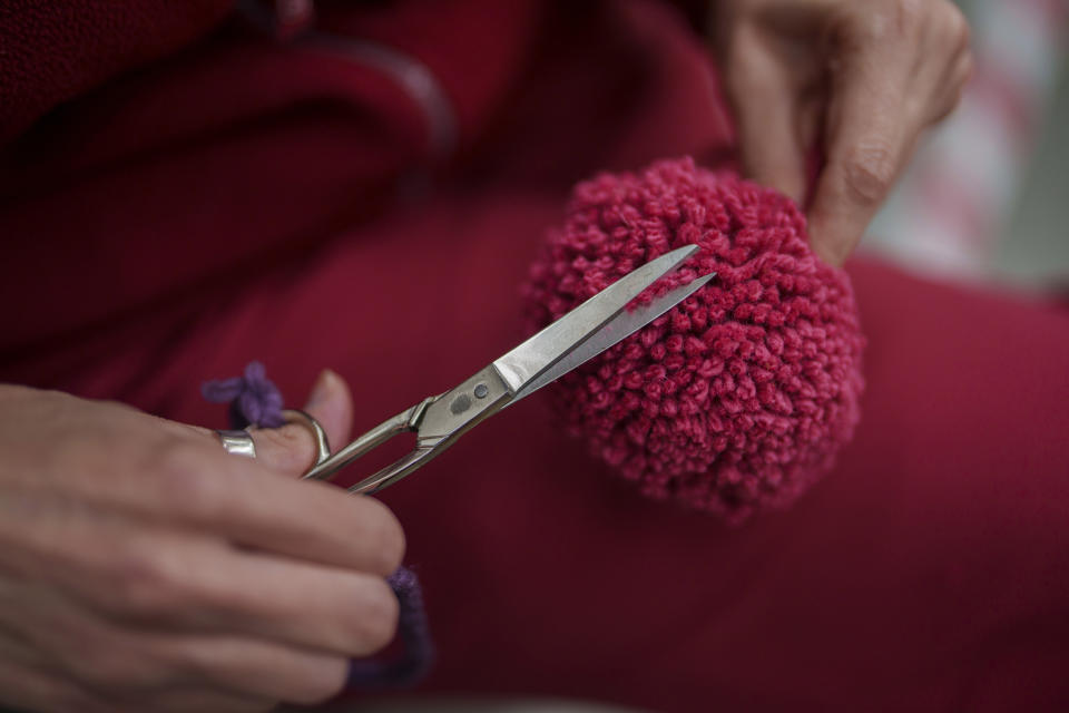 A craftswoman works on the details of a tapestry at the Royal Tapestry Factory in Madrid, Spain, Friday, Nov. 30, 2023. Since its foundation in 1721, the Royal Tapestry Factory of Madrid has not stopped producing. It was Philip V, then King of Spain, who had the factory built with the help of Catholic craftsmen from Flanders to replace the lack of private initiative that existed at the time. (AP Photo/Manu Fernandez)