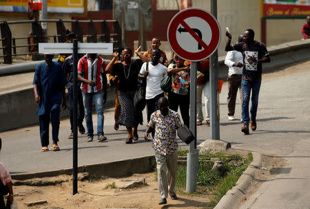 People run as they leave the port of Abidjan after they heard gunfire, in Abidjan, Ivory Coast January 18,2017. REUTERS/Luc Gnago