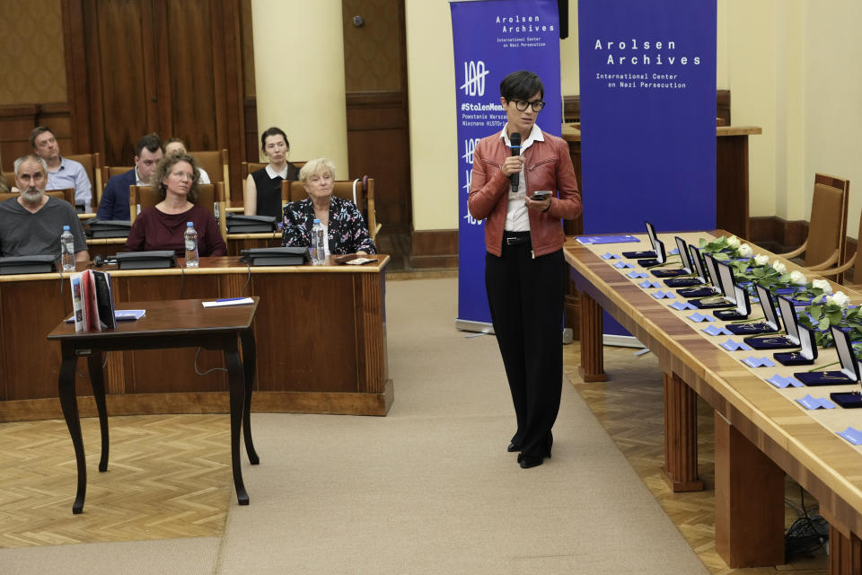 The director of Germany's Arolsen Archives, Floriane Azoulay, talks to the relatives of 12 inmates of World War II Nazi Germany's concentration camps at the start of a ceremony in which the relatives were given back personal items and jewellery that the Nazis had seized from them during the war and which were recently stored at the archives, in Warsaw, Poland, Tuesday Sept. 10, 2024. (AP Photo/Czarek Sokolowski)