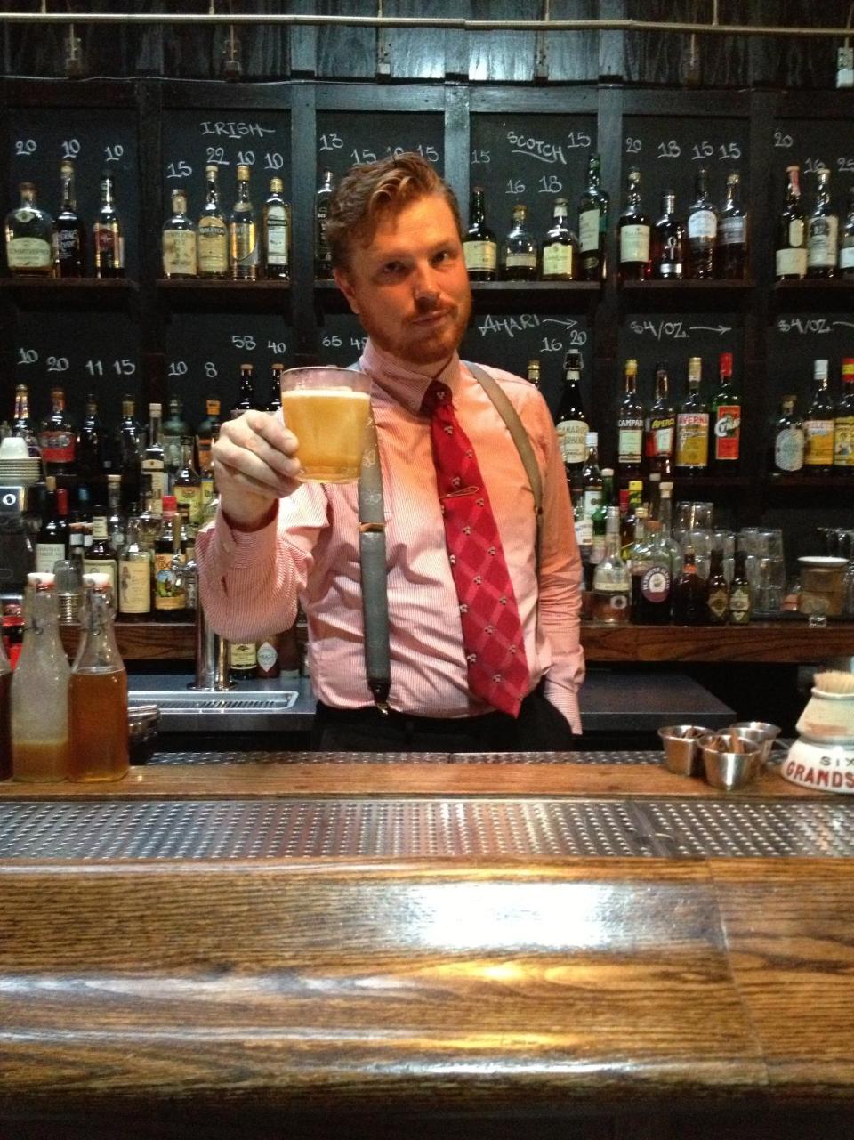 This undated photo provided by Dutch Kills shows head bartender Jan Warren holding a drink at Dutch Kills, a bar in the Long Island City section of the Queens borough of New York. Long Island City and the adjacent neighborhood of Astoria are becoming popular destinations for tourists lured by moderately priced hotels just across the river from Manhattan, along with the area’s attractions, which include museums, waterfront parks, and ethnic food. Dutch Kills is located on a somewhat desolate industrial street but inside it offers a warm and welcoming vibe with artisanal cocktails. (AP Photo/Dutch Kills)