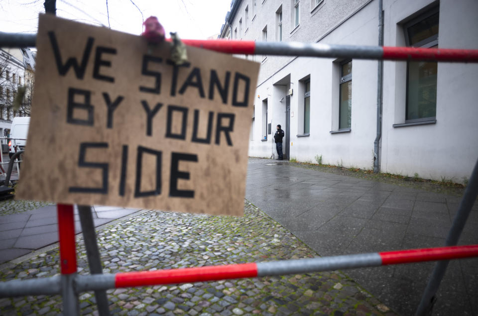 FILE - A police officer guards at the entrance of the building complex of the Kahal Adass Jisroel community, which houses a synagogue, a kindergarten and a community center, in the center of Berlin, Germany, on Nov. 8, 2023. The complex in the city's Mitte neighbourhood was attacked with two incendiary devices on Oct. 18, 2023. (AP Photo/Markus Schreiber, File)