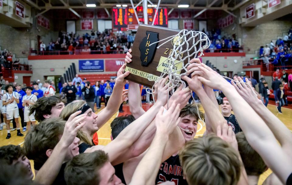 The Metamora Redbirds celebrate their Class 3A supersectional title after defeating Marmion Academy 60-48 on Monday, March 6, 2023 at Ottawa High School.