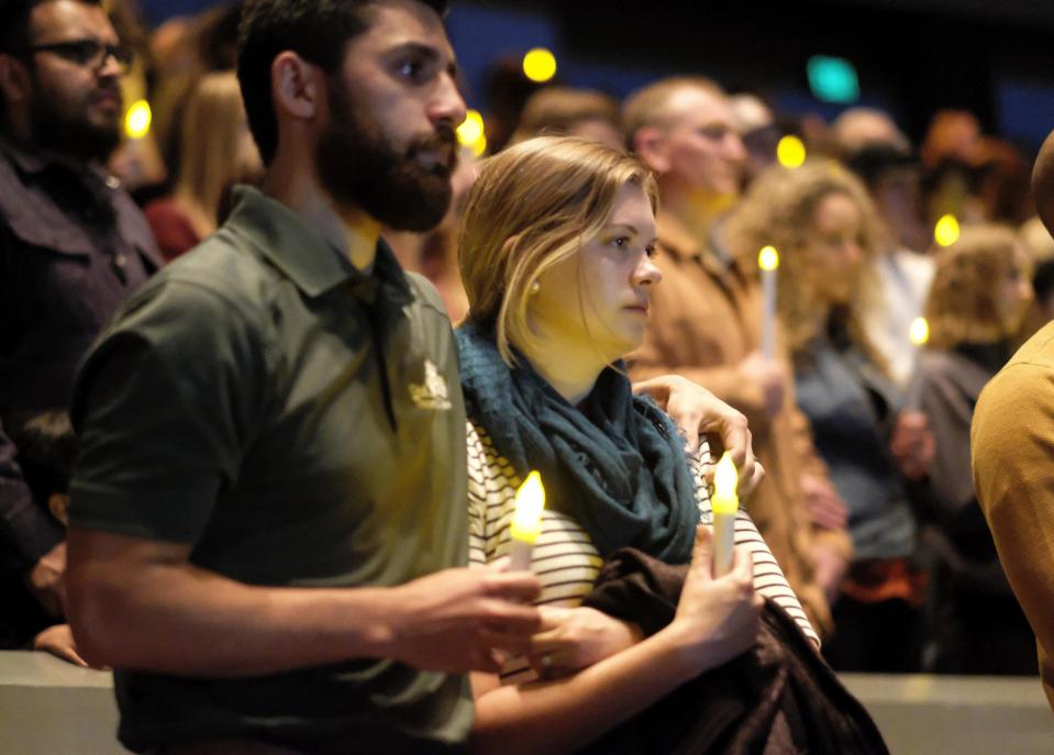 People gather to pray for the victims of the mass shooting during a candlelight vigil in Thousand Oaks , Calif., Thursday, Nov. 8, 2018. A gunman opened fire Wednesday evening inside a country music bar, killing multiple people. (AP Photo/Ringo H.W. Chiu)