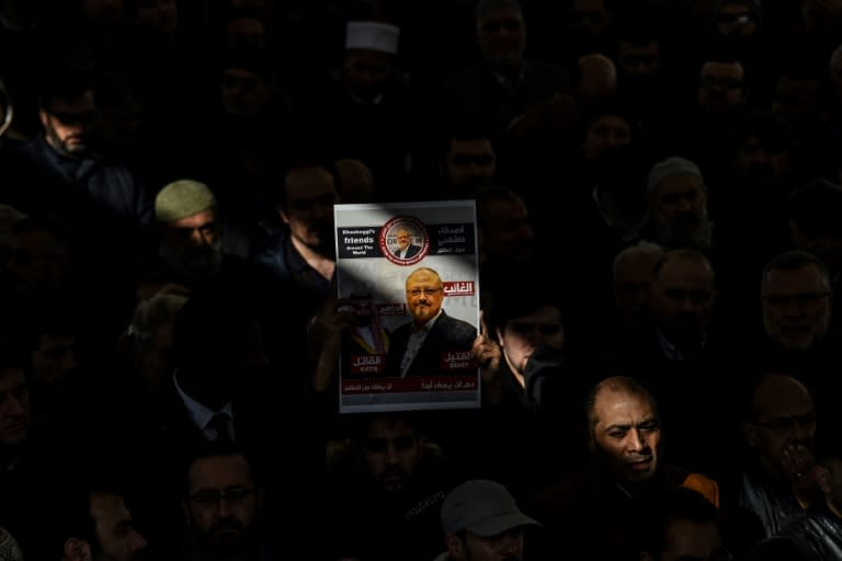 A person holds a banner of Jamal Khashoggi during a symbolic funeral prayer for the Saudi journalist at the courtyard of Fatih mosque in Istanbul, on November 16, 2018