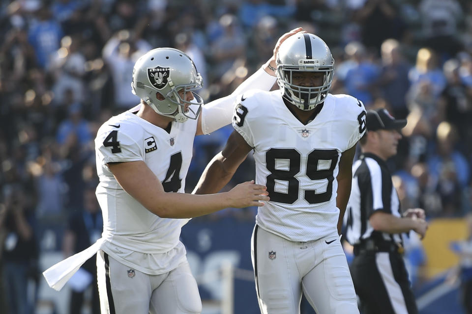 The duo of Raiders quarterback Derek Carr (L) and wide receiver Amari Cooper struggled this season. (AP) 