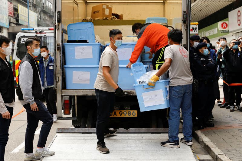 FILE PHOTO: Movers collect boxes of evidence after a police search at the office of Stand News, in Hong Kong