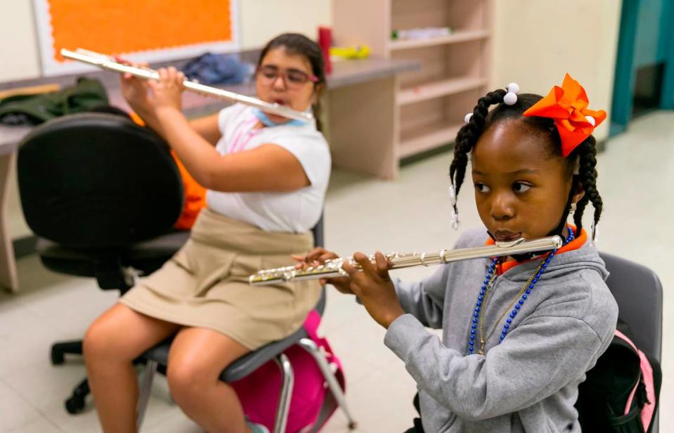 Kayana Chataigne, 8, right, plays the flute during a Miami Music Project practice session at Carol City Elementary in Miami Gardens.