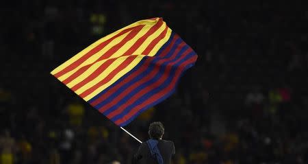 Barcelona coach Luis Enrique celebrates with a flag after winning the UEFA Champions League. Reuters / Dylan Martinez