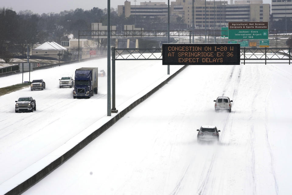 FILE - In this Feb. 15, 2021, file photo, an electronic message board advises drivers of potential congestion as they drive over snow on Interstate 55 in north Jackson, Miss. There have been record subzero temperatures in Texas and Oklahoma, and Greenland is warmer than normal. Snow fell in Greece and Turkey. Meteorologists blame the all-too-familiar polar vortex. (AP Photo/Rogelio V. Solis, File)