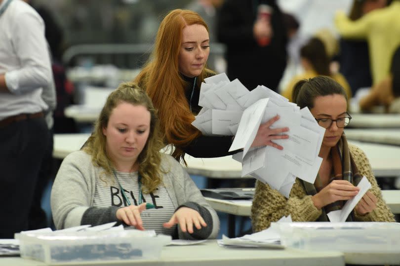 Staff begin counting ballot papers at a count centre