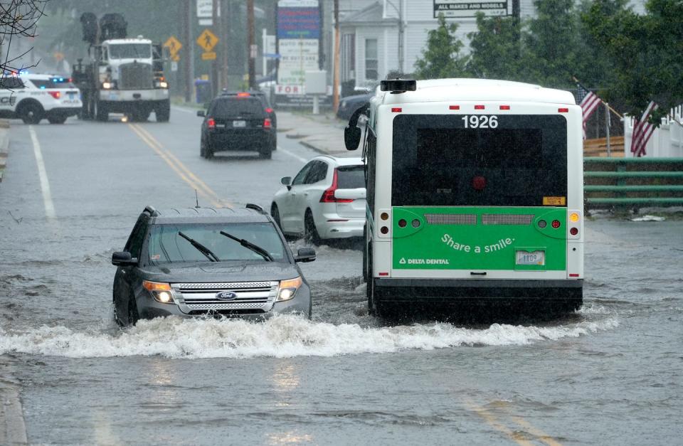 Afternoon downpours flood portions of Douglas Avenue in front of the North Providence Marketplace on July 10, forcing a temporary closing of a section of road.