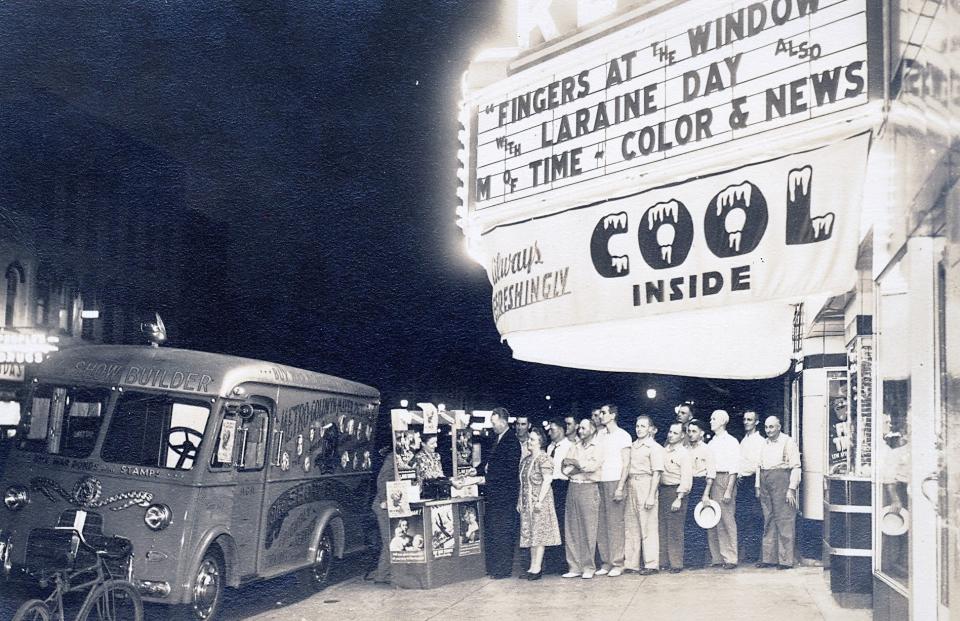 Air conditioning was a big attraction for the Rees theater in downtown Plymouth, seen here in 1942, because it was a rarity. Here, moviegoers lined up to purchase war bonds from the Metro-Goldwyn-Mayer "Show Builder" panel truck before a movie started.