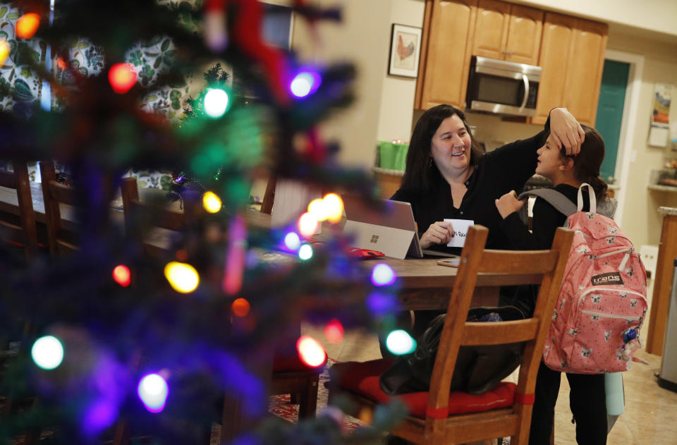 Rochelle Thuy Nguyen greets her daughter Hannah Lay at their home, Tuesday, Dec. 18, 2018, in Las Vegas. Nevada became the first state in the U.S. with an overall female majority in the Legislature on Tuesday when county officials in Las Vegas appointed Nguyen and another women to fill vacancies in the state Assembly. (AP Photo/John Locher)