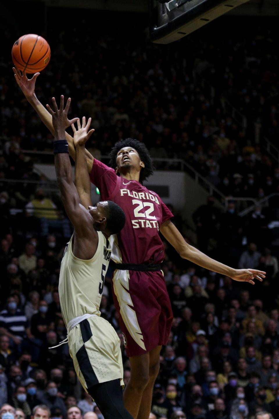 Florida State forward John Butler (22) grabs the rebound above Purdue guard Brandon Newman (5) during the first half of an NCAA men's basketball game, Tuesday, Nov. 30, 2021 at Mackey Arena in West Lafayette.