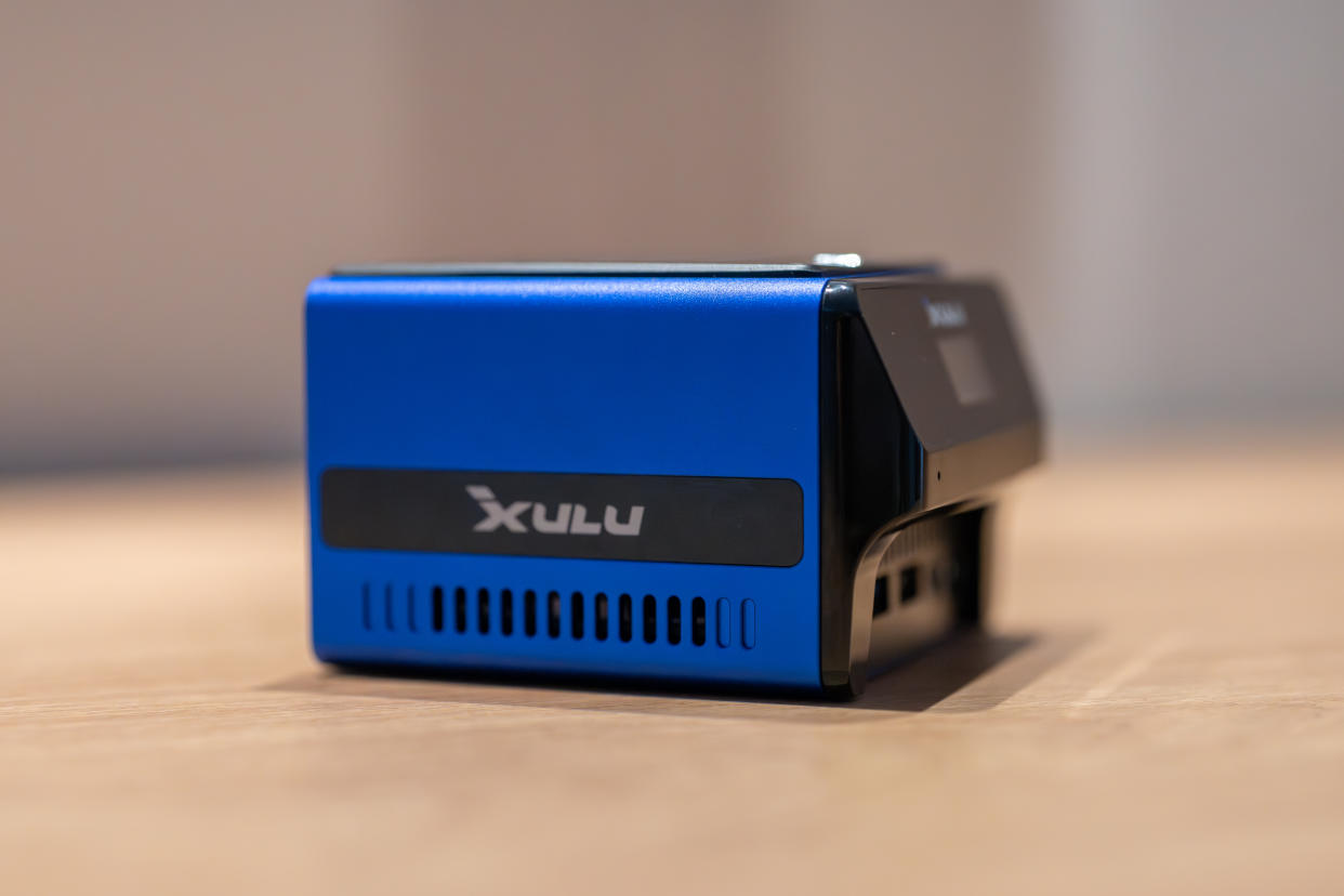  A blue and black Xulu XR1 Max mini PC on a wooden desk 