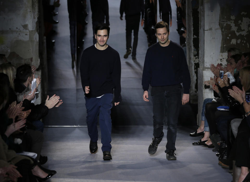 Designers Jack McCollough, right, and Lazaro Hernandez greet the crowd after the Proenza Schouler Fall 2013 collection is shown during Fashion Week in New York, Wednesday, Feb. 13, 2013. (AP Photo/Seth Wenig)