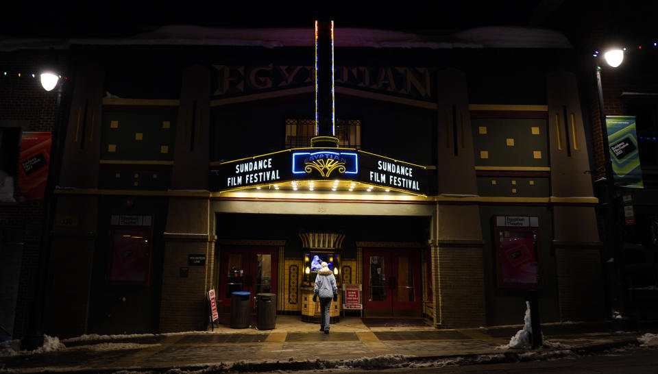 A pedestrian peers into the ticket booth of the Egyptian Theatre before the start of the 2023 Sundance Film Festival, Wednesday, Jan. 18, 2023, in Park City, Utah. The annual independent film festival runs from Jan. 19-29. (AP Photo/Chris Pizzello)