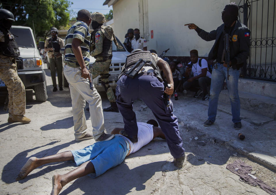 An inmate is recaptured outside the Croix-des-Bouquets Civil Prison after an attempted breakout, in Port-au-Prince, Haiti, Thursday, Feb. 25, 2021. At least seven people were killed and one injured on Thursday after eyewitnesses told The Associated Press that several inmates tried to escape from a prison in Haiti’s capital. (AP Photo/Dieu Nalio Chery).