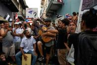 Members of theatre group Papel Machete perform during a protest calling for the resignation of Governor Ricardo Rossello in front of La Fortaleza in San Juan