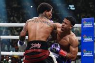 Rolando Romero, right, punches Gervonta Davis during the fourth round of a WBA lightweight championship boxing bout early Sunday, May 29, 2022, in New York. Davis won in the sixth round. (AP Photo/Frank Franklin II)