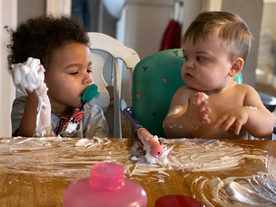 Kendrick Brisco, 1, looks at Josiah Gingerich, also 1, as they smear shaving cream on the kitchen table at the home of child care provider Wendy Tilma in Byron Center, Michigan.