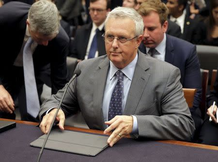 Bruce Sewell, senior vice president and general counsel for Apple Inc., sets up his iPad before testifying to the House Judiciary hearing on "The Encryption Tightrope: Balancing Americans' Security and Privacy" on Capitol Hill in Washington March 1, 2016. REUTERS/Joshua Roberts