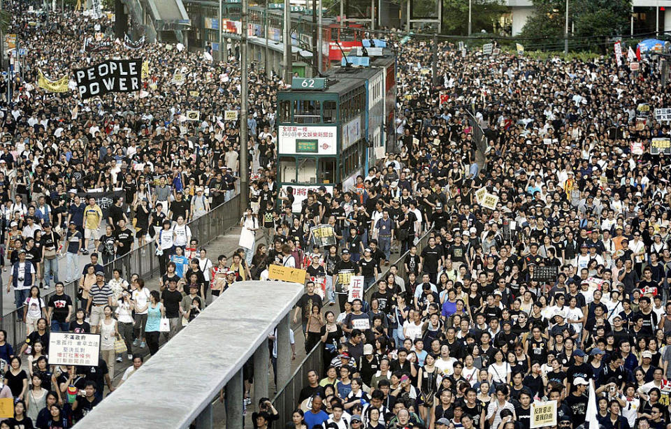 Trams sit stranded as thousands of people block the streets in a huge protest march against a controversial anti-subversion law known as Article 23 in Hong Kong on July 1, 2003. | Peter Parks—AFP/Getty Images