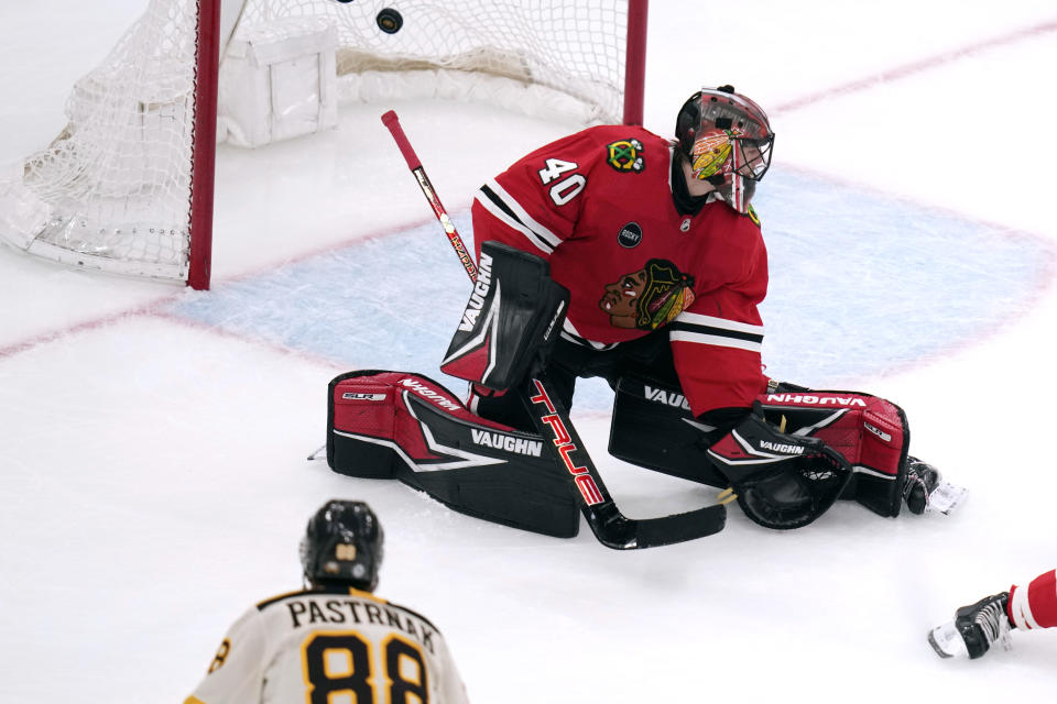 Boston Bruins right wing David Pastrnak (88) scores against Chicago Blackhawks goaltender Arvid Soderblom (40) during the second period of an NHL hockey game Wednesday, Oct. 11, 2023, in Boston. (AP Photo/Charles Krupa)