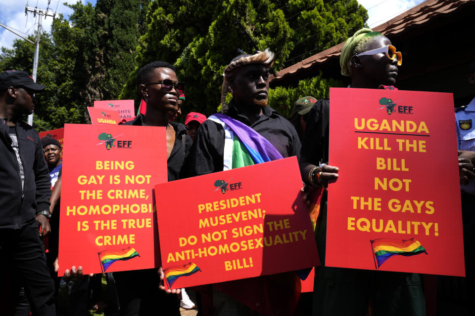 Activists hold placards during their picket against Uganda's anti-homosexuality bill at the Ugandan High Commission in Pretoria, South Africa, Tuesday, April 4, 2023. Uganda's legislature last week passed the anti-homosexuality bill. The legislation is now with President Yoweri Museveni, who can sign it into law or return it back to the parliamentary speaker with proposed changes. (AP Photo/Themba Hadebe)
