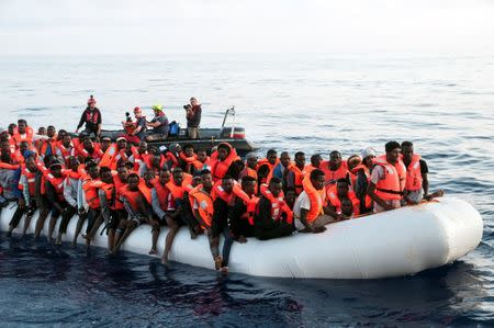 Migrants are seen in a rubber dinghy as they are rescued by the crew of the Mission Lifeline rescue boat in the central Mediterranean Sea, June 21, 2018. Picture taken June 21, 2018. Hermine Poschmann/Misson-Lifeline/Handout via REUTERS