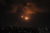 Rockets fired by Palestinian militants toward Israel are seen over Gaza City, Saturday, Aug. 6, 2022. The latest confrontation between Israel and Gaza militants is in its second day, as Israeli jets hit targets in Gaza and rocket fire persists into southern Israel. Palestinian officials say at least 15 people have been killed in Gaza, including a senior militant leader and a 5-year-old girl. (AP Photo/Adel Hana)