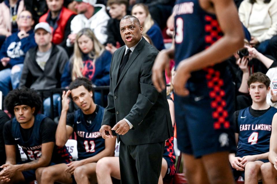 East Lansing's head coach Ray Mitchell looks on from the bench during the first quarter in the game against Okemos on Thursday, Jan. 25, 2024, at Okemos High School.