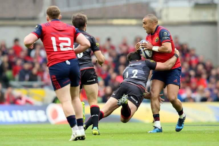 Munster's full-back Simon Zebo (R) is tackled by Saracens' Brad Barritt (2R) during their rugby union Champions Cup semi-final match in Dublin on April 22, 2017