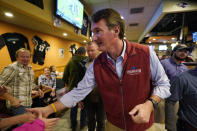 Virginia Republican gubernatorial candidate Glenn Youngkin greets supporters during a meet and greet at a sports bar in Chesapeake, Va., Monday, Oct. 11, 2021. Youngkin faces former Governor Terry McAuliffe in the November election. (AP Photo/Steve Helber)