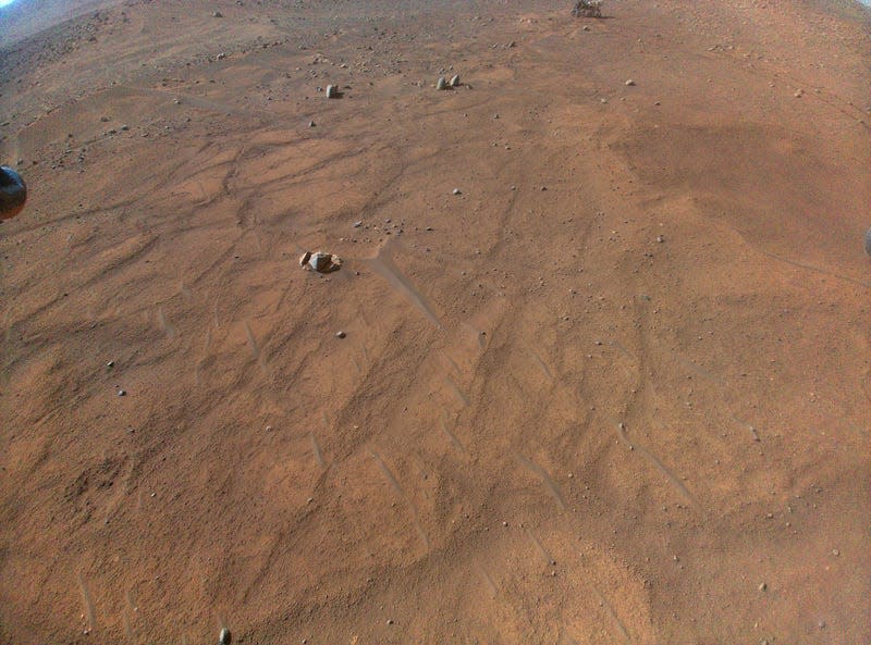 The Perseverance rover can be seen at the very top of this image taken by the Ingenuity helicopter during its 54th flight.