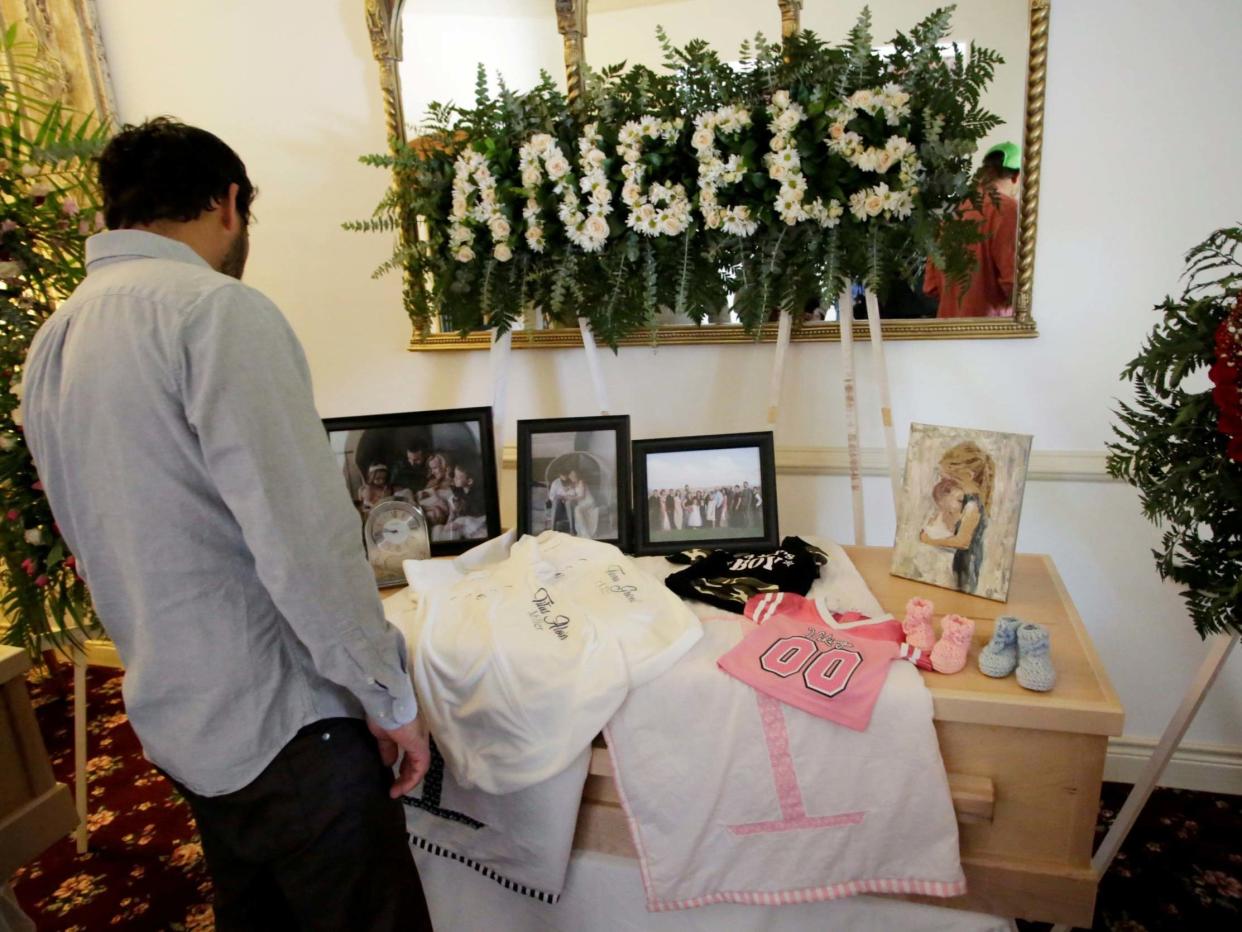 A person observes framed photographs of Rhonita Maria Miller and her four children, members of the Mexican-American Mormon community killed by unknown assailants, before her funeral in La Mora, in La Mora, Sonora state, Mexico 7 November 2019: REUTERS