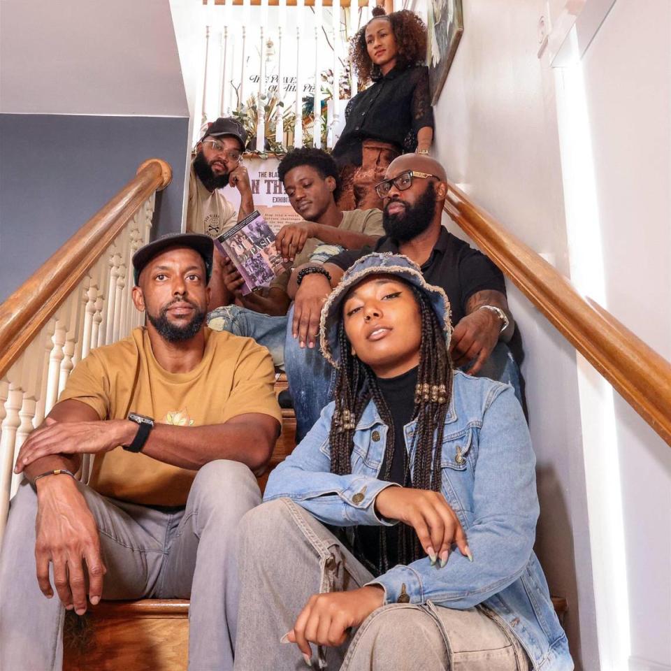 Contributing artists of “On the Ban Wagon: The Power of the Pen”: Melissa Martinez, top, Everton Allen, Godwin Ferrier (with book), Anthony Lumpkin, Nate Dee, bottom left, and Tierra Armstrong, right, all find space among the steps of the D.A. Dorsey House in Overtown.