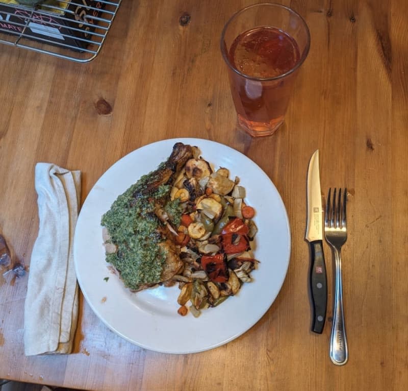 plate of grilled vegetables with green sauce