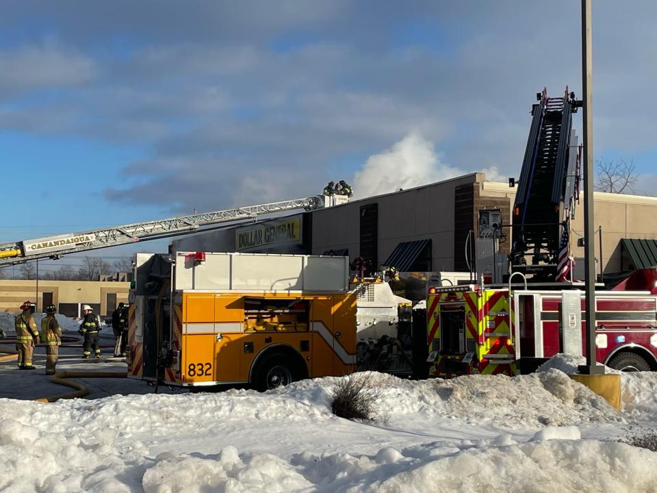 Fire crews battle a fire at the Dollar General store in Farmington on Thursday.