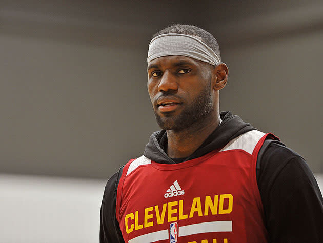 LeBron James watches the clock. (Getty Images)